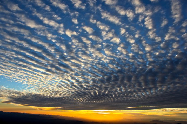 Interesting cloud patterns following the sun as it sinks below the horizon.