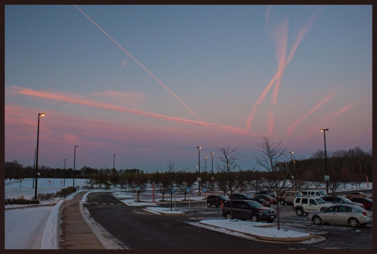 Contrails from planes at Dulles International Airport create a beautiful sunset